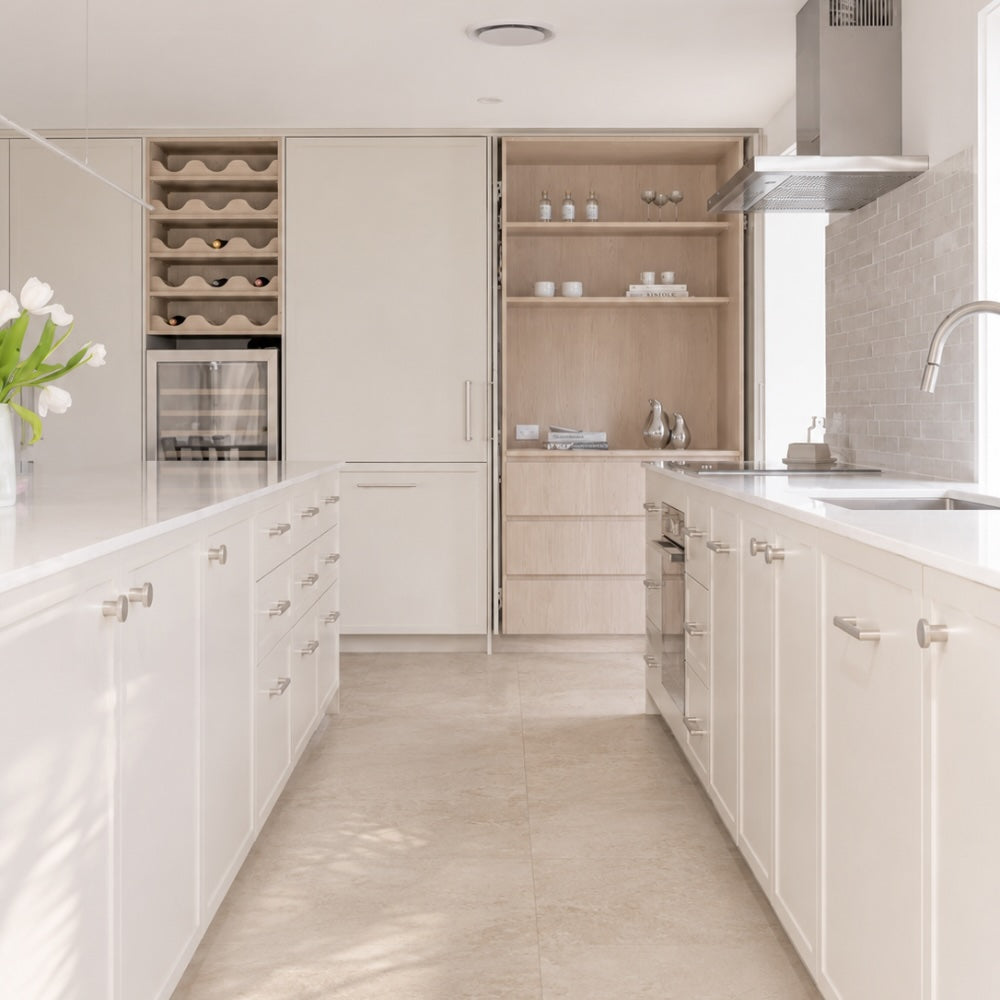 Refined coastal interior featuring soft nickel hardware and natural stone