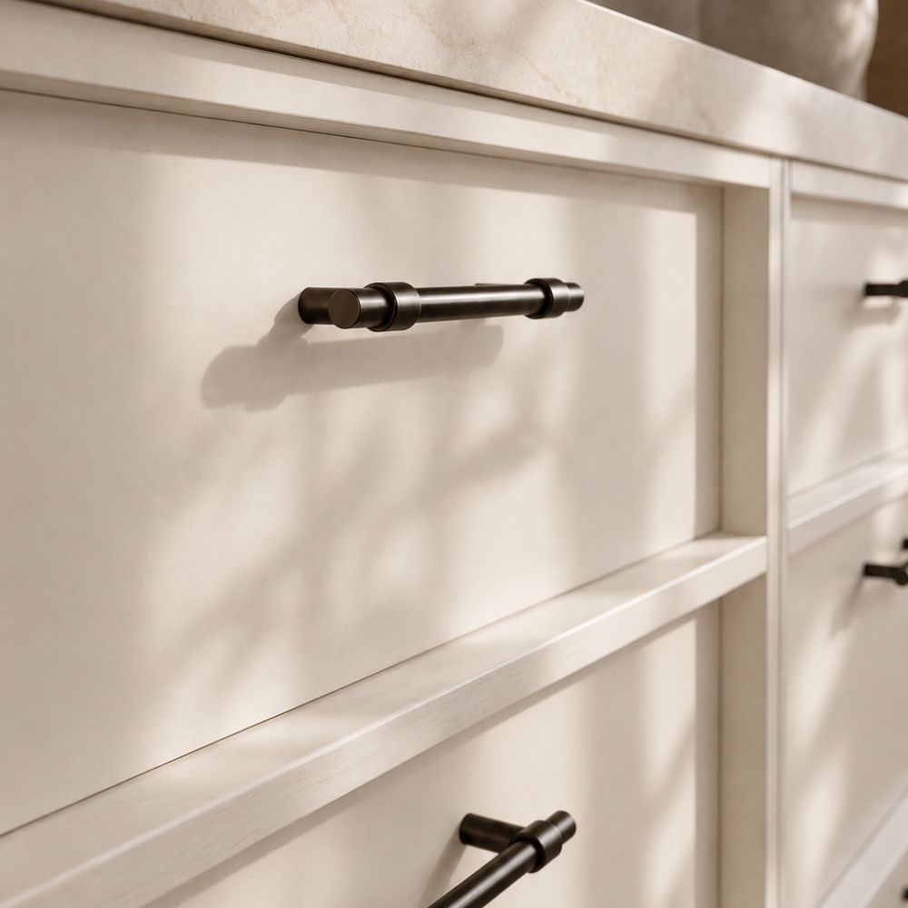 Helsinki cabinet pulls in Signature Brass on warm white kitchen cabinetry
